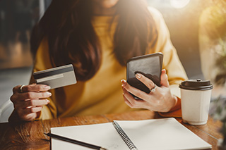 woman holding credit cards