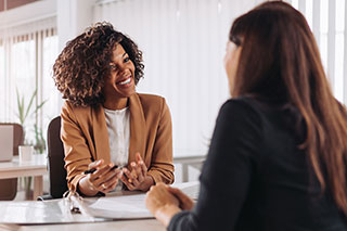 two women talking at bankers office